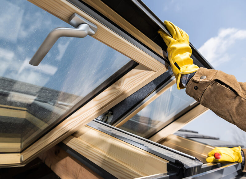 New Wooden Roof Windows Installation in Newly Built Residential Building. Construction Industry Theme.