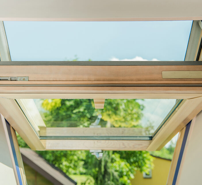 Closeup of an Open Wooden Roof Window. Brand New Installation at Residential Building.